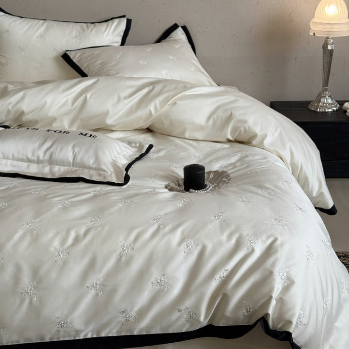 Noble cotton satin bedding set with tone-on-tone floral embroidery and contrasting piping