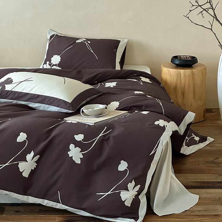 Reversible cotton satin bedding set with floral silhouette print and contrasting piped edge