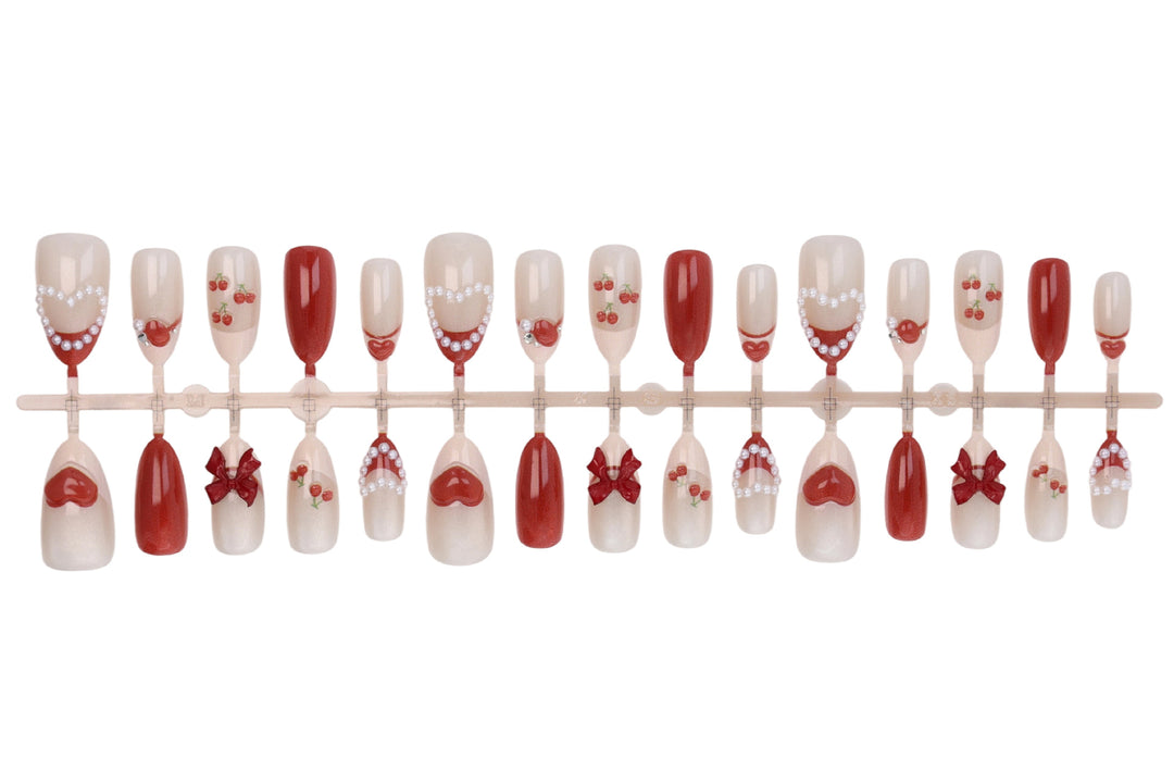 Artificial nail set with romantic berry designs and glamorous embellishments Stornfield