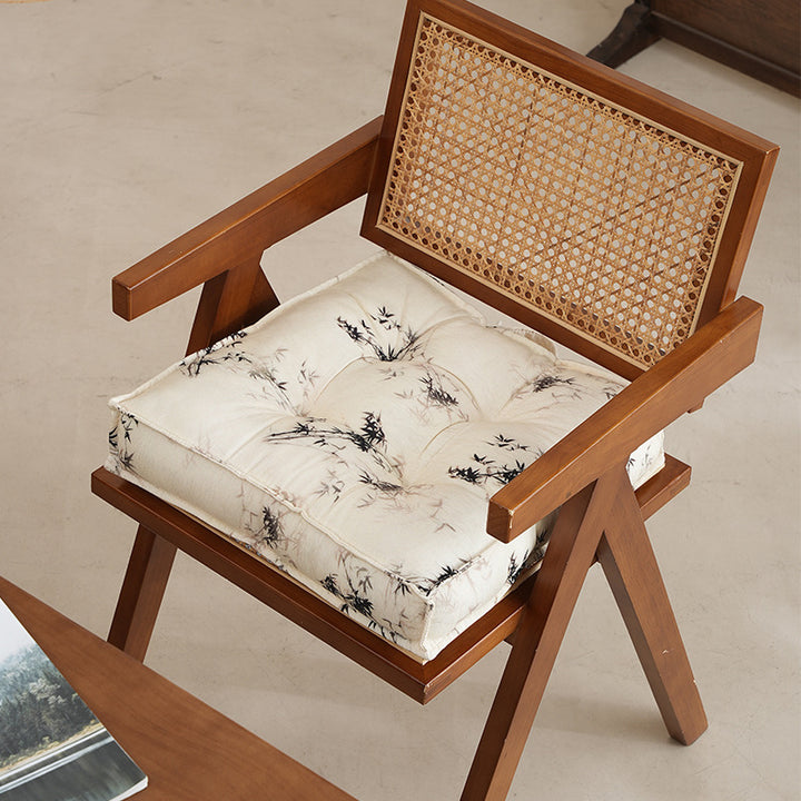 Padded seat cushion with tufting and bamboo motif