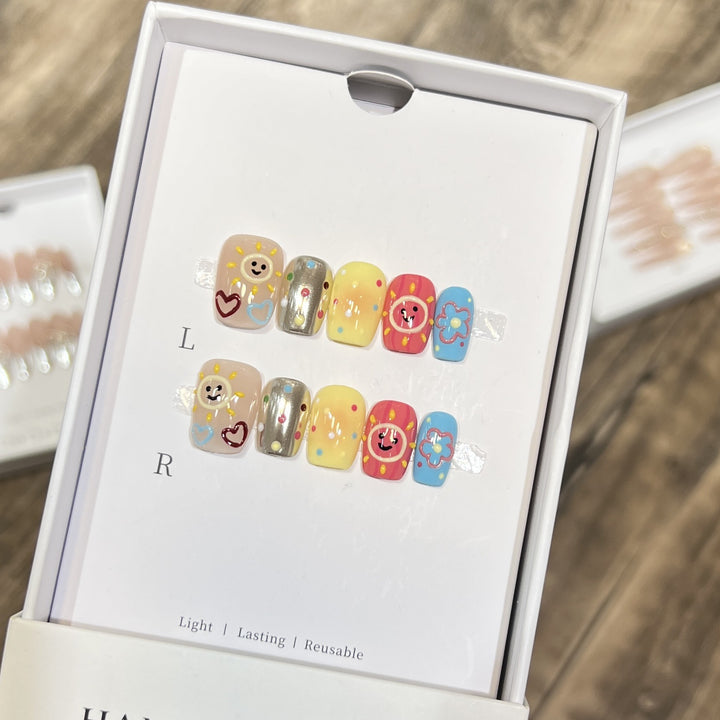 Whimsical Press-On Nail Art Set with Smiley Faces and Floral Designs Stornfield