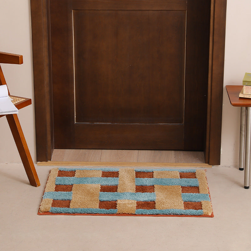 Rectangular tufted door mat with geometric block pattern and non-slip backing Stornfield