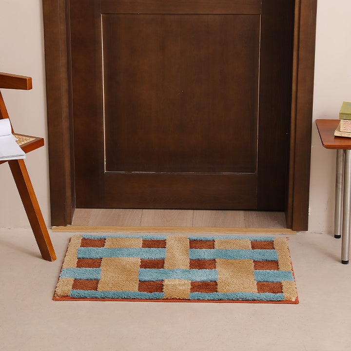 Rectangular tufted door mat with geometric block pattern and non-slip backing Stornfield