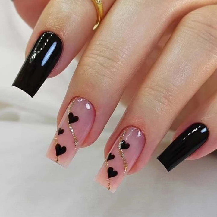 Artistic acrylic nails with heart design and glitter accents Stornfield