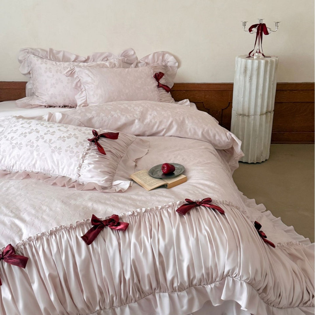 Luxurious satin bedding set with ruffles and decorative bows