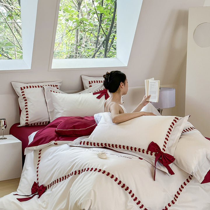 Reversible cotton satin bedding set with decorative bow appliqués