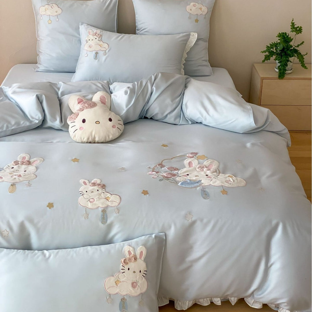 Playful children's bedding set made of silky-soft cotton satin with appliquéd bunnies and cuddly pillow