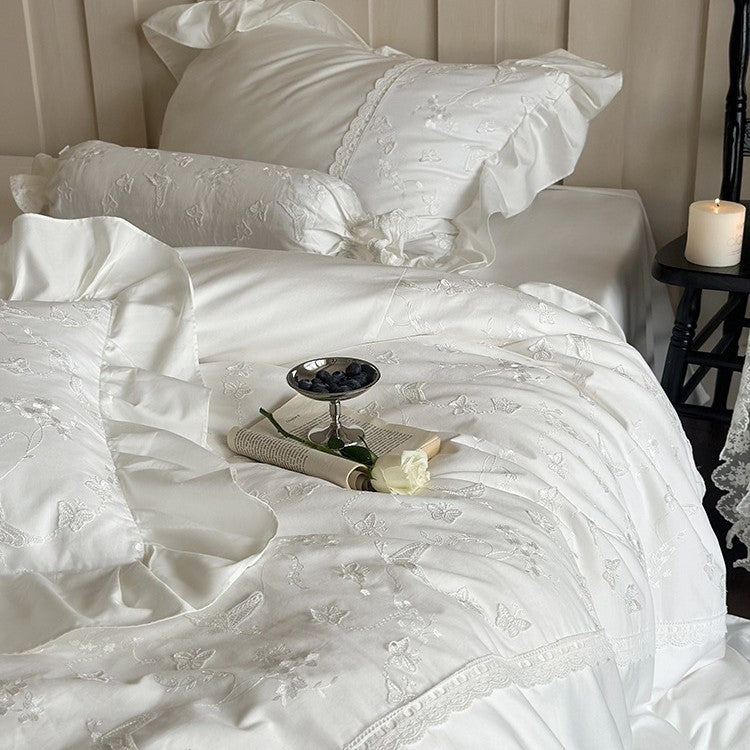 Luxurious satin bedding set with ruffles, lace trim, and fine embroidery