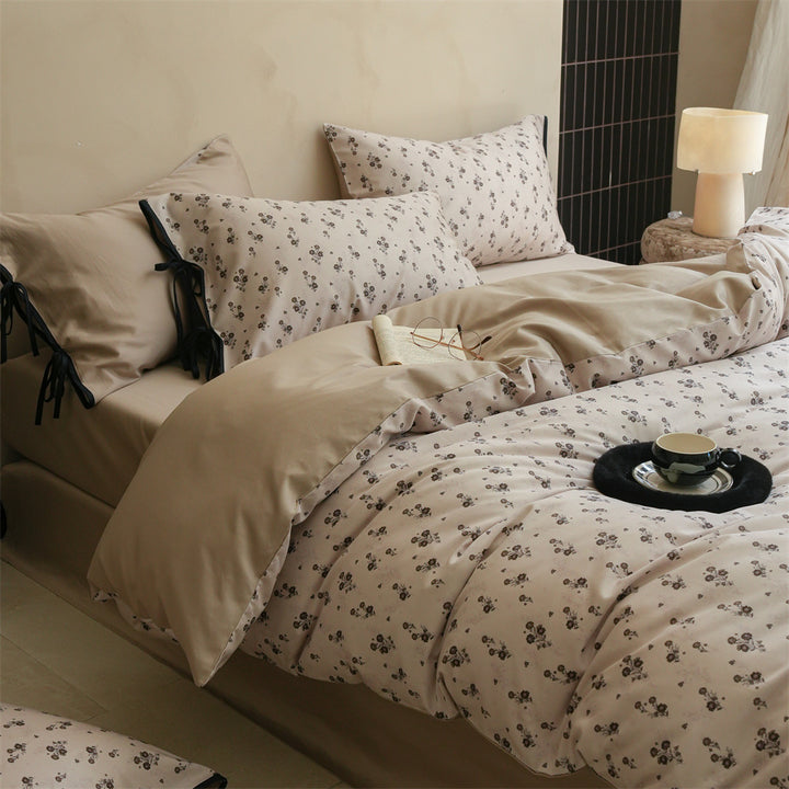 Bedding set made of cotton satin with fine floral microprint and decorative ribbons