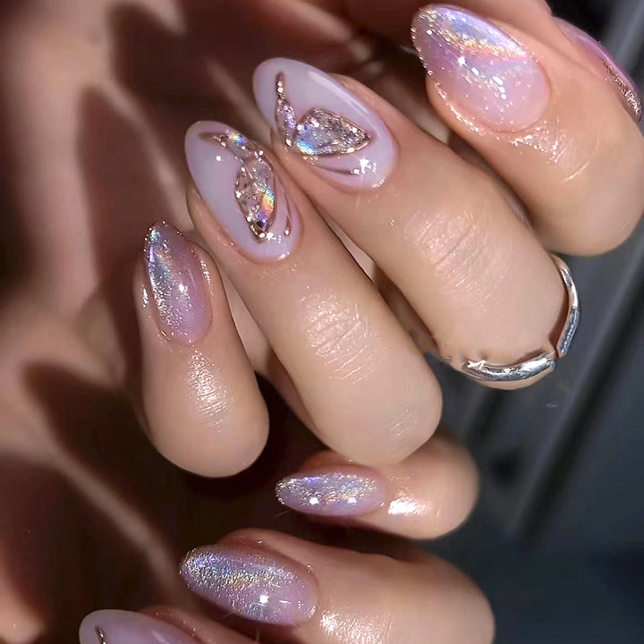 Glamorous artificial nails with rhinestone and glitter decorations Stornfield