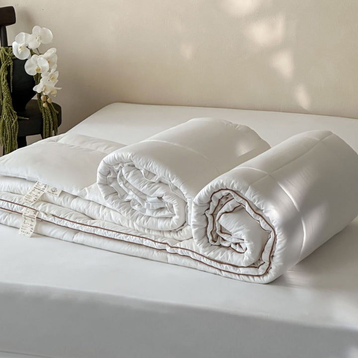 Padded comfort topper with quilted compartments and elastic corner bands