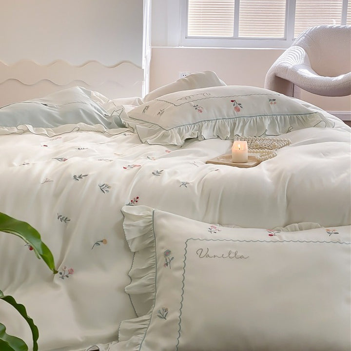 Romantic cotton satin bedding set with delicate floral embroidery and ruffle trim