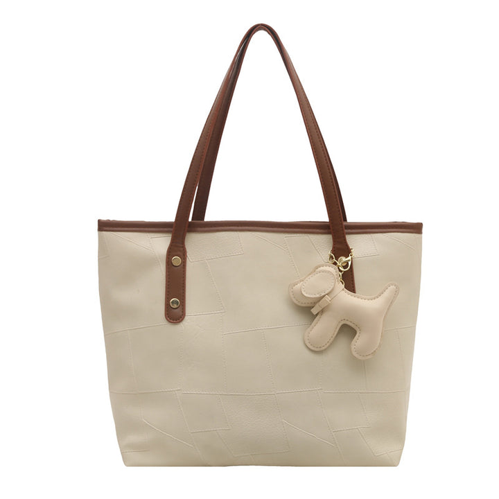 Stylish Textured Tote Bag with Decorative Charm