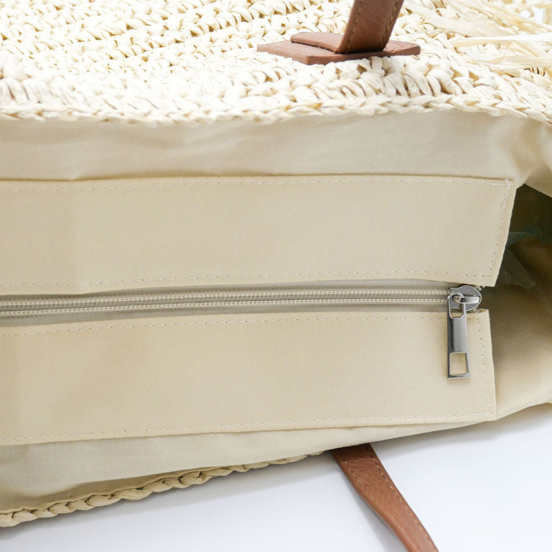 Beach bag made of handwoven straw with fringes Stornfield