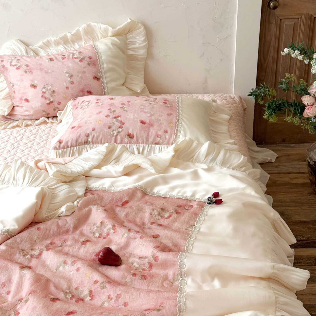 Romantic bedding set with ruffles, quilted bedspread, and decorative pillowcases