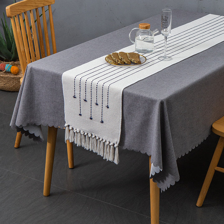 Decorative table runner in Scandinavian-minimalist design with macrame fringes Stornfield