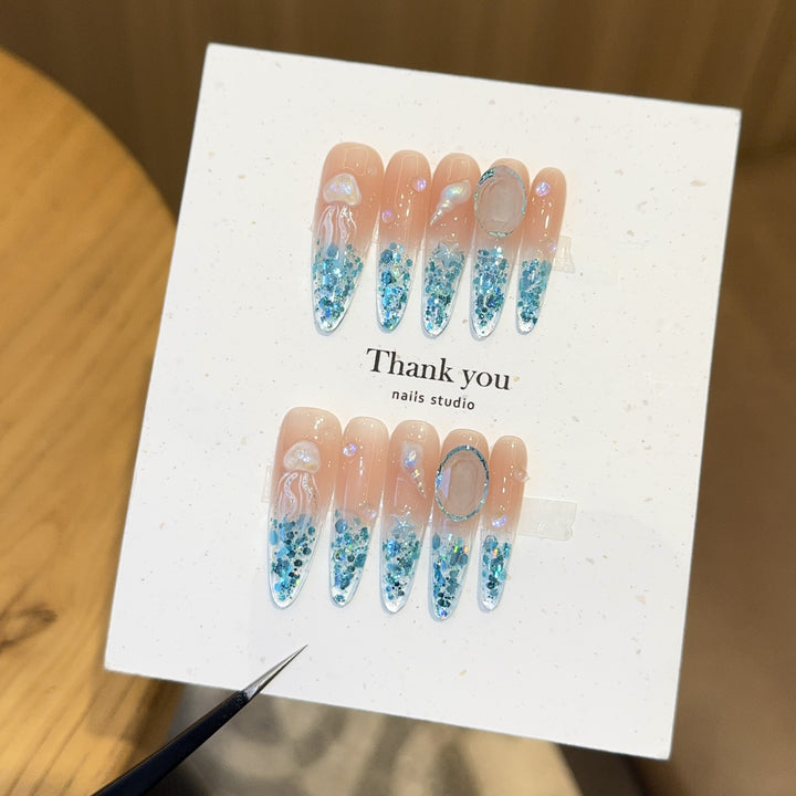 Creative artificial nails with maritime designs and sparkling accents Stornfield
