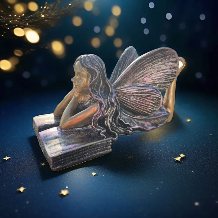 Fairy Figurine Sitting on Books Stornfield