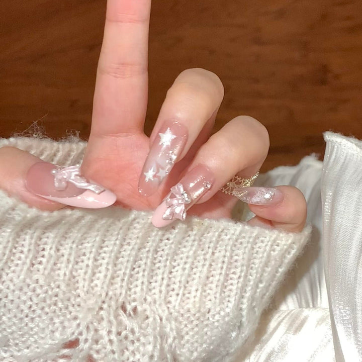 Artificial nail tips with glamorous glitter and bow details Stornfield