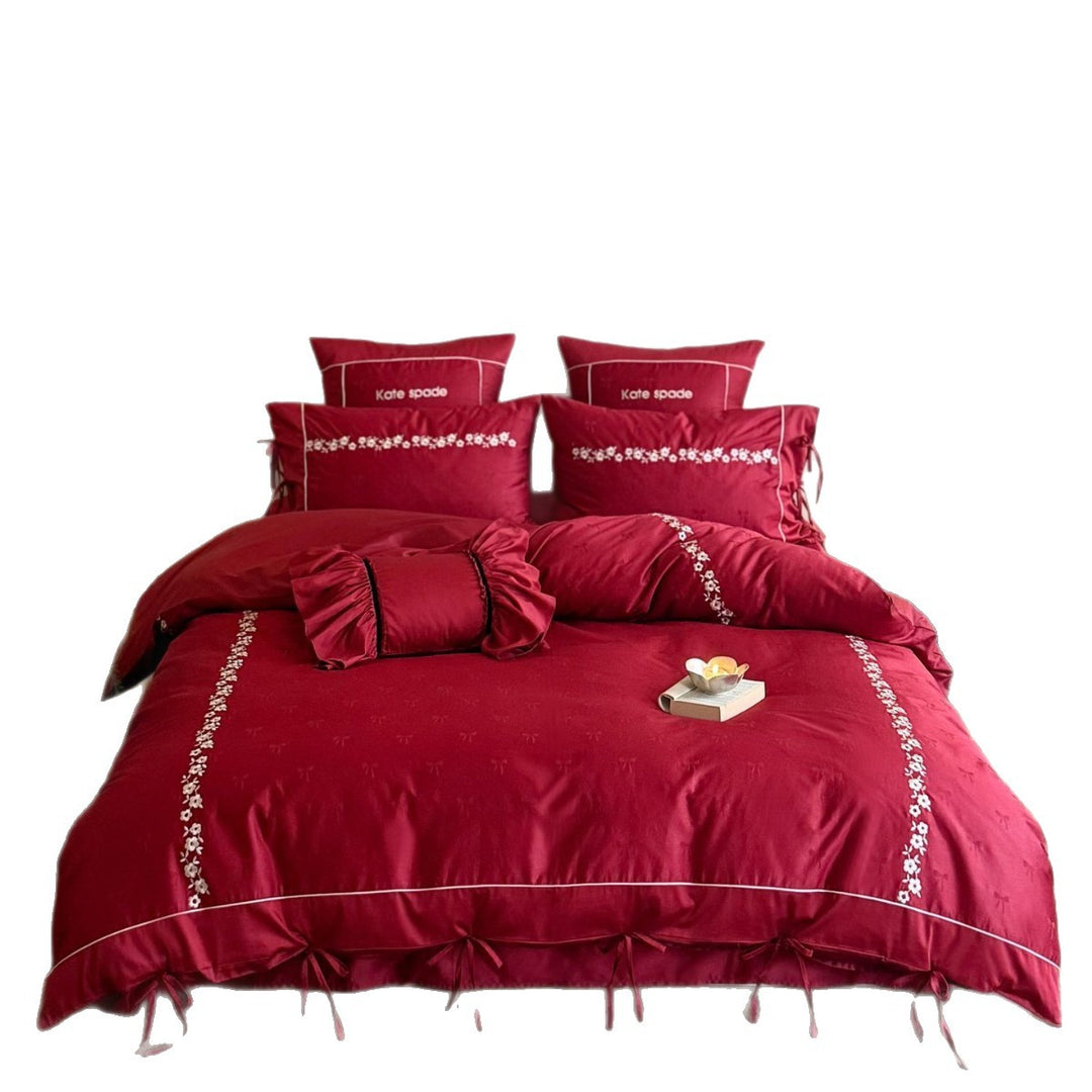 Bedding set made of cotton satin with floral border embroidery, decorative bows and pillow ensemble