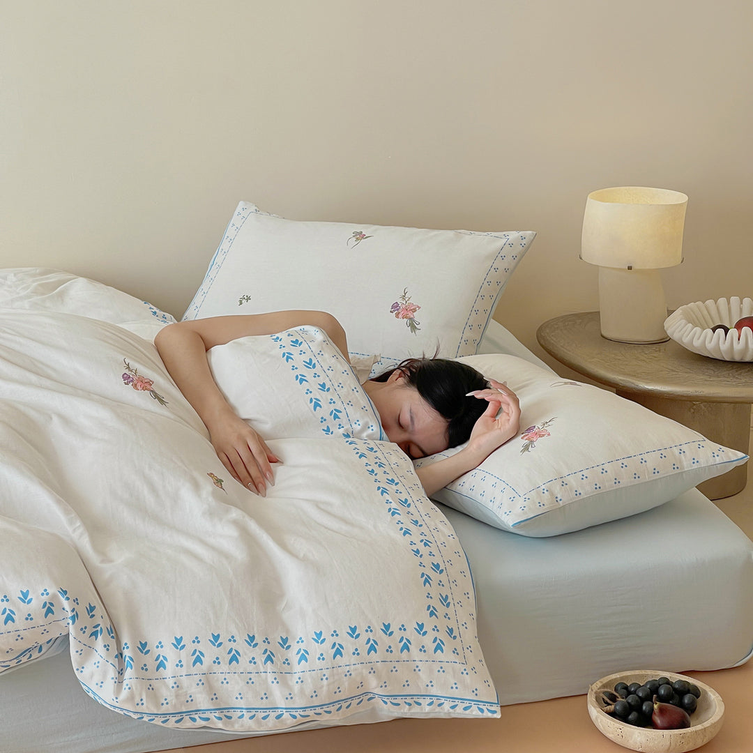Cotton bedding set with delicate floral embroidery and decorative border