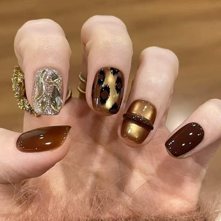 Glamorous artificial nails with animal design and glitter accents Stornfield