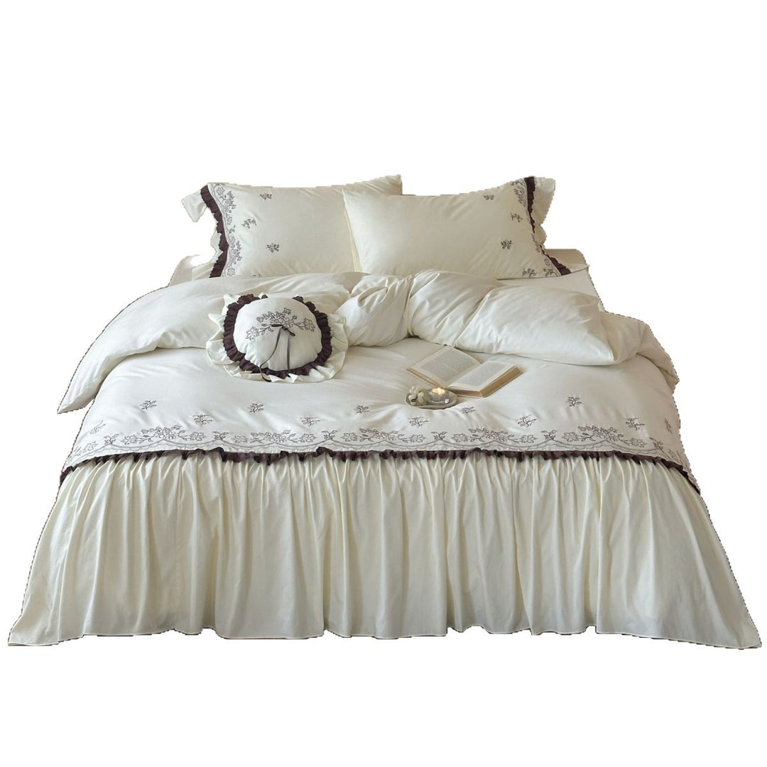 High-quality embroidered bedding set with ruffled bed skirt and decorative cushion