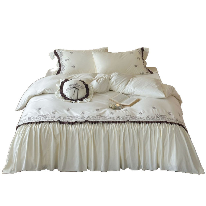High-quality embroidered bedding set with ruffled bed skirt and decorative cushion