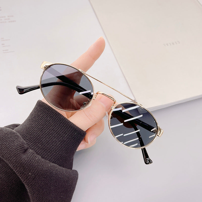 Ladies fashionable sunglasses in stylish round design with golden accents Stornfield