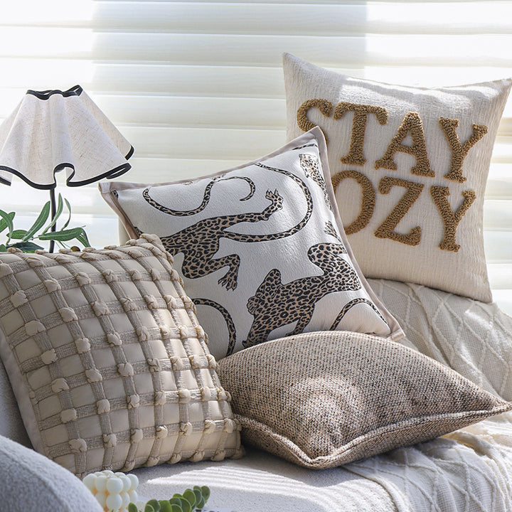 Square decorative cushion cover made of mottled bouclé weave with subtle piping Stornfield