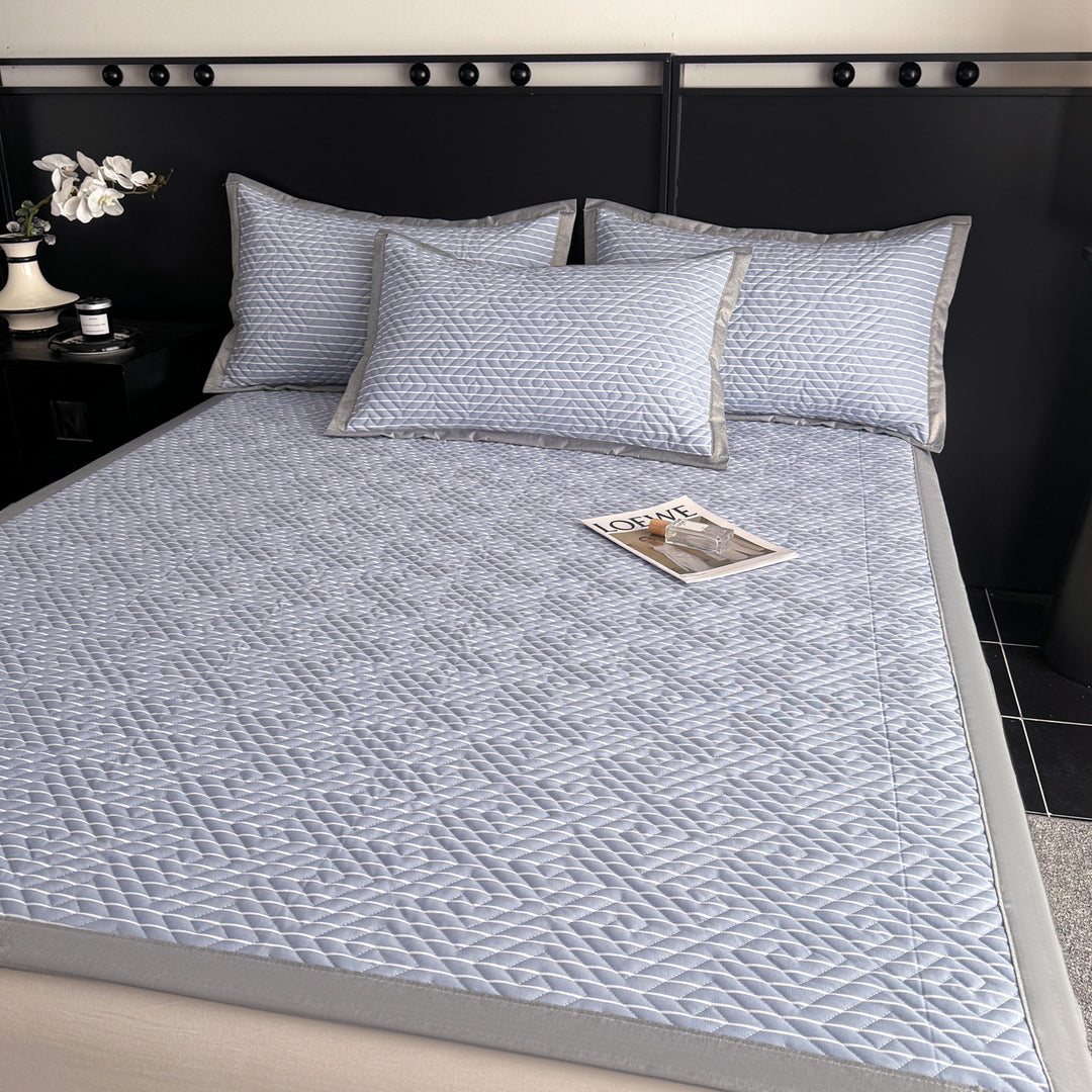 Quilted bedspread and pillow set with geometric striped quilting