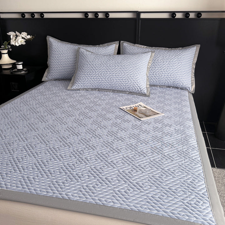 Quilted bedspread and pillow set with geometric striped quilting