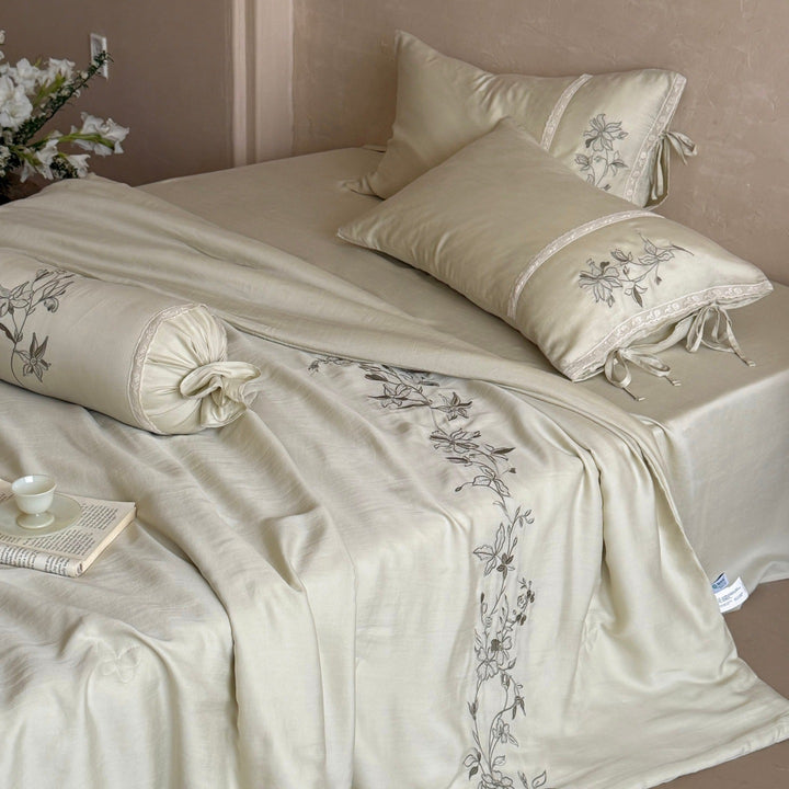 Elegant bedding set made of cotton satin with floral embroidered border and decorative roll cushion Stornfield