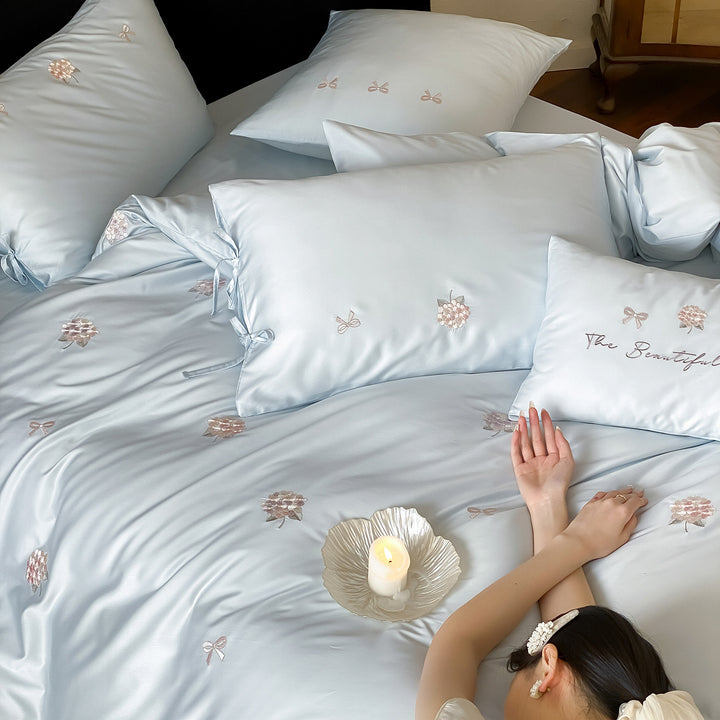 Cotton satin bedding set with delicate bow and flower embroidery as well as pillowcases