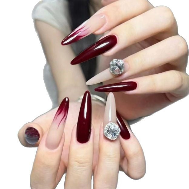 Elegant Stiletto Nail Enhancements with Gem Accents Stornfield