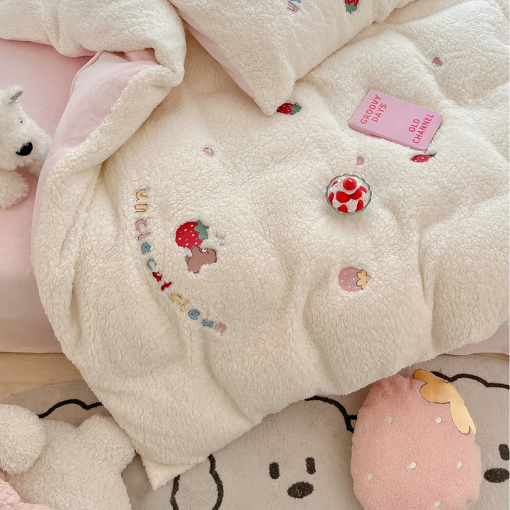 Plush quilt with teddy fleece, embroidered strawberry appliqués and reversible function
