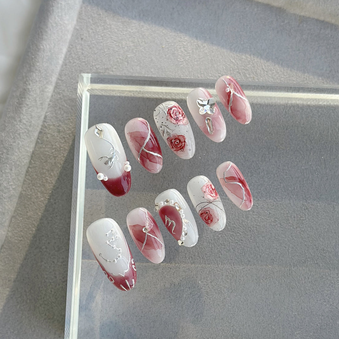 Artistic Press-On Nail Set with Floral Designs and Gem Accents