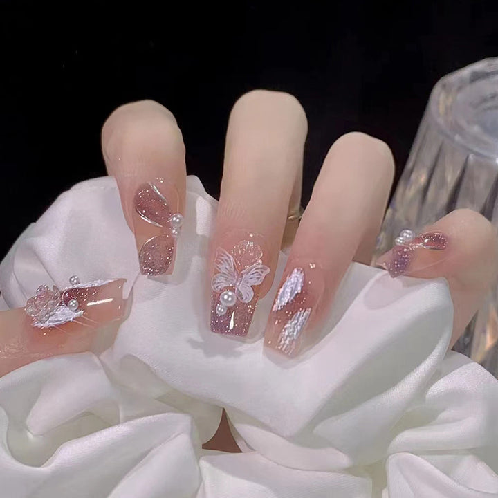 Glamorous artificial nails with delicate flower and glitter effects Stornfield