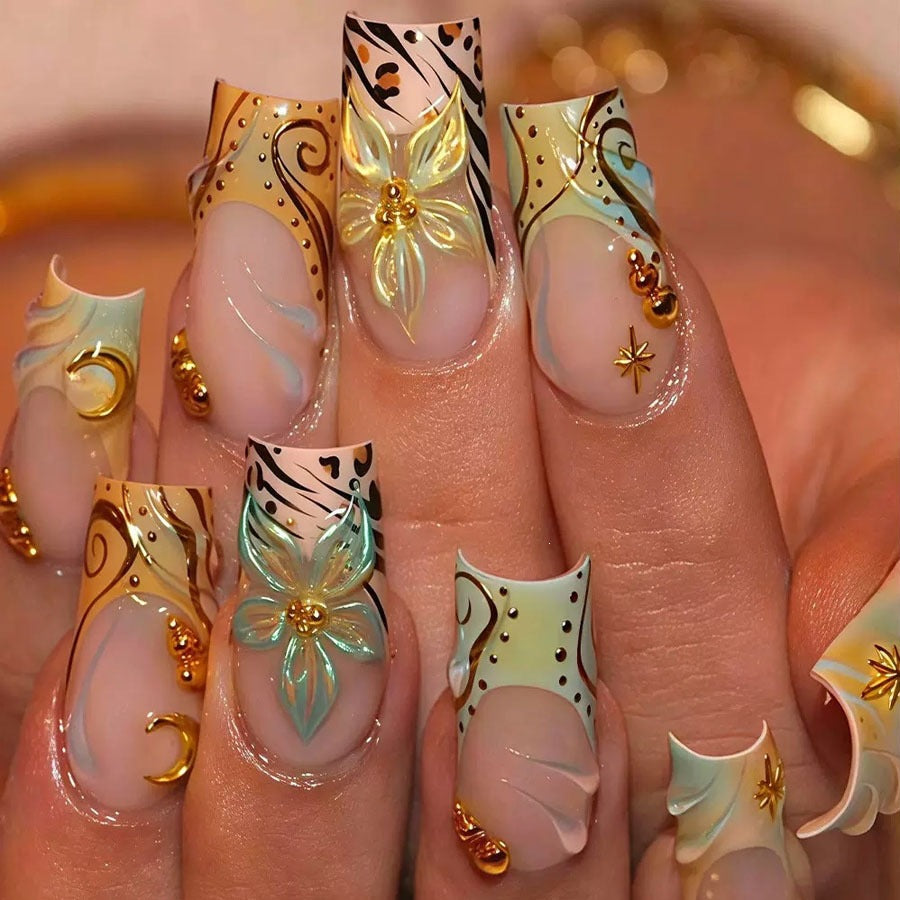 Luxurious artificial nail set with creative floral design and golden accents Stornfield