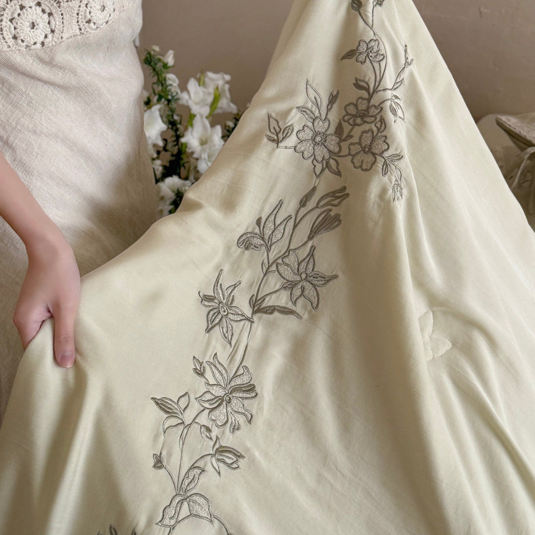 Elegant bedding set made of cotton satin with floral embroidered border and decorative roll cushion Stornfield