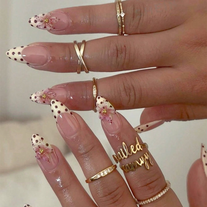Acrylic nail set with romantic dots and floral accents Stornfield