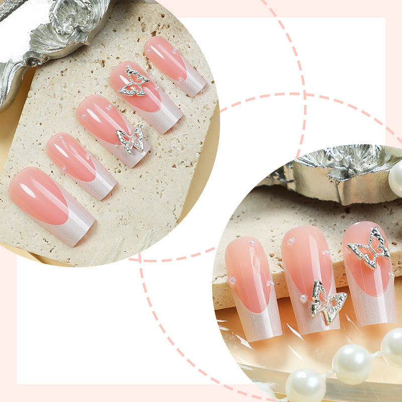 Nail art set with intricate designs and butterfly appliqués Stornfield