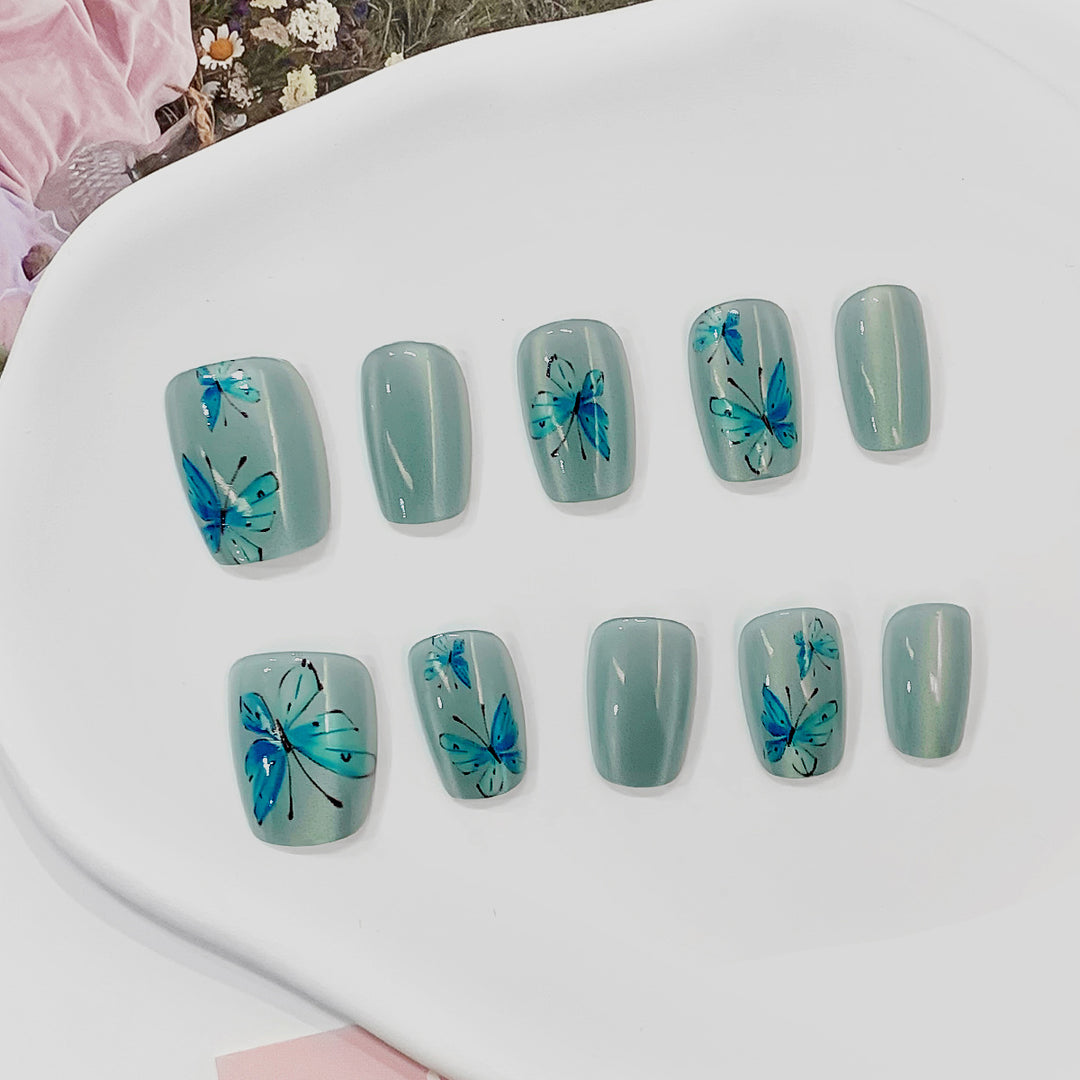 Artistic acrylic nails with butterfly motif Stornfield