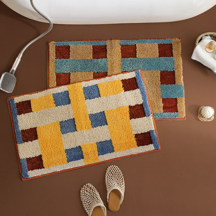Rectangular tufted door mat with geometric block pattern and non-slip backing Stornfield