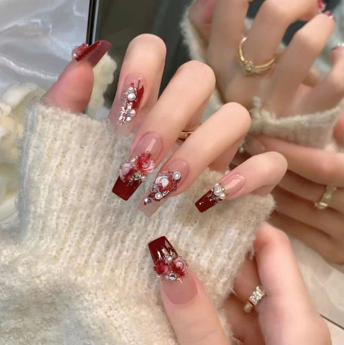 Artistic Nail Art with Glitter and Flower Applications Stornfield