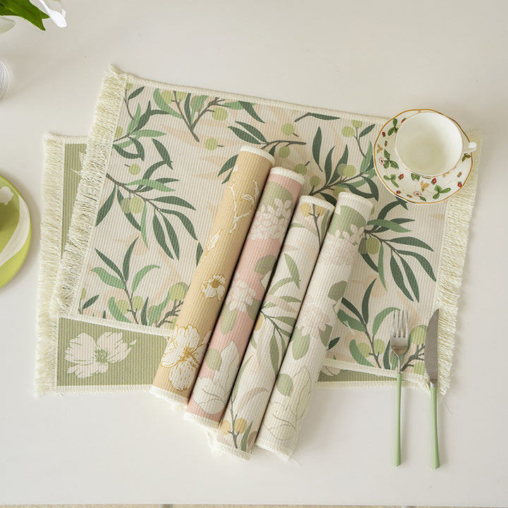 Woven table placemat made of cotton blend with olive branch print and decorative fringe edge