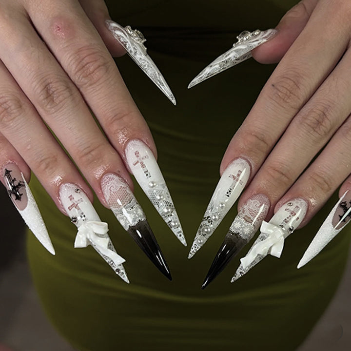Artful stiletto nails with unique 3D elements and glitter accents Stornfield