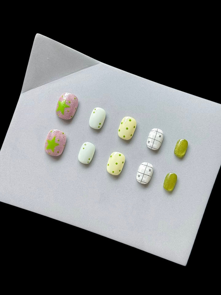 Playful Press-On Nail Art Set with Fun Patterns and Glitter Accents