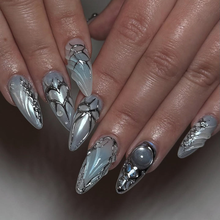 Artful stiletto nails with playful metallic details Stornfield
