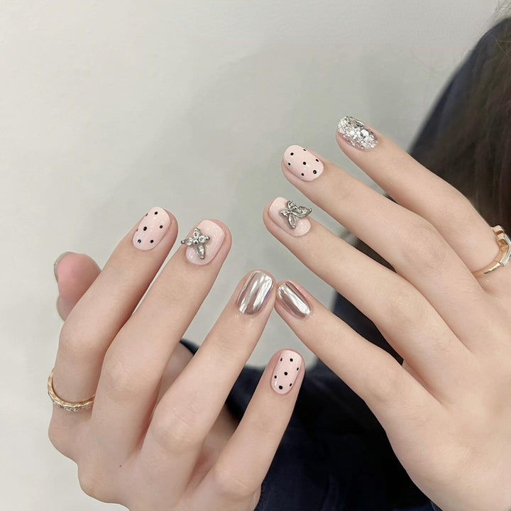 Artificial nails with playful design and glitter accents Stornfield